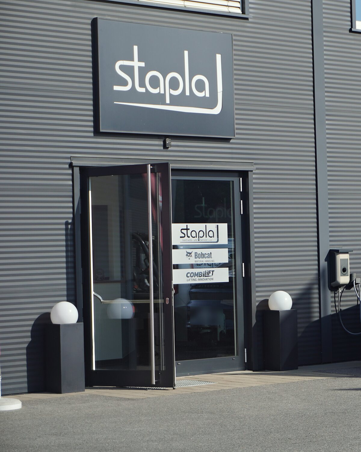 Eingang von stapla mit Firmenschild und Bobcat- und Combilift-Zeichen an der Tür